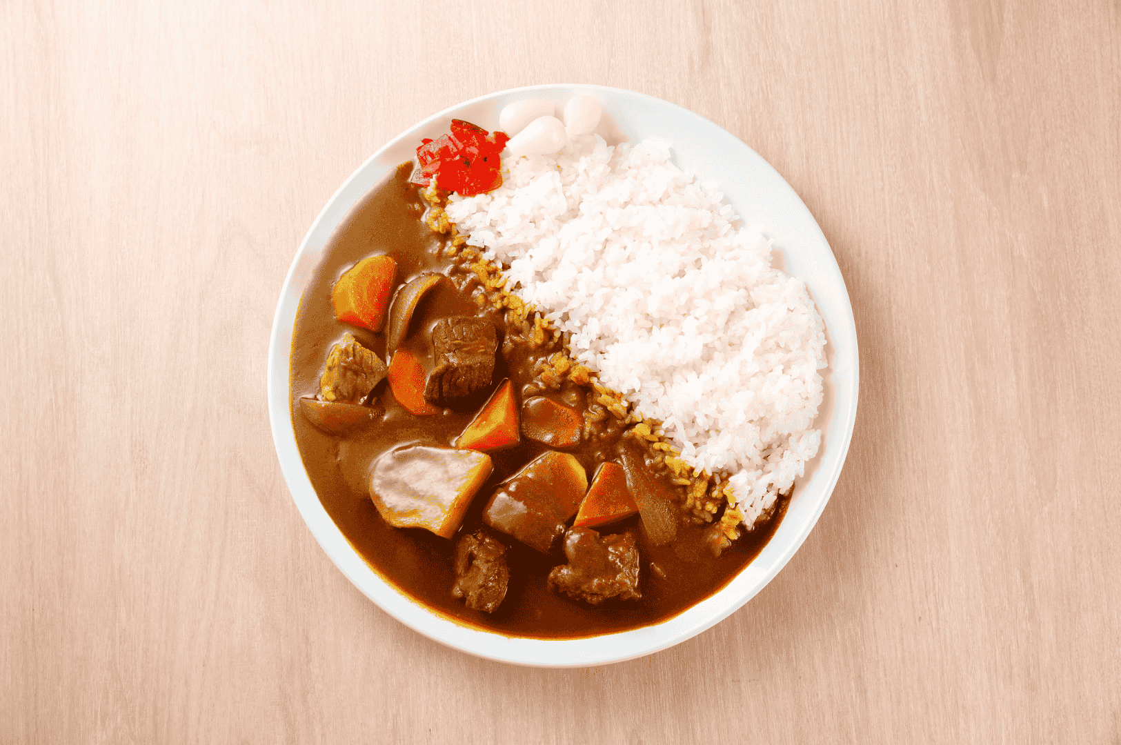 Plate of Japanese curry rice with beef, potatoes, and pickled ginger—offering a hearty, comforting option for late-night diners exploring Singapore Chinatown’s after-dark restaurant scene.