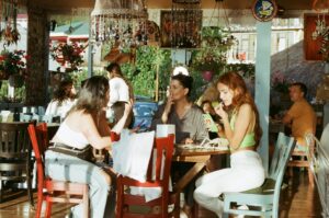 Diners gathered around a table at a restaurant in Kampong Glam, sharing local dishes and conversation.