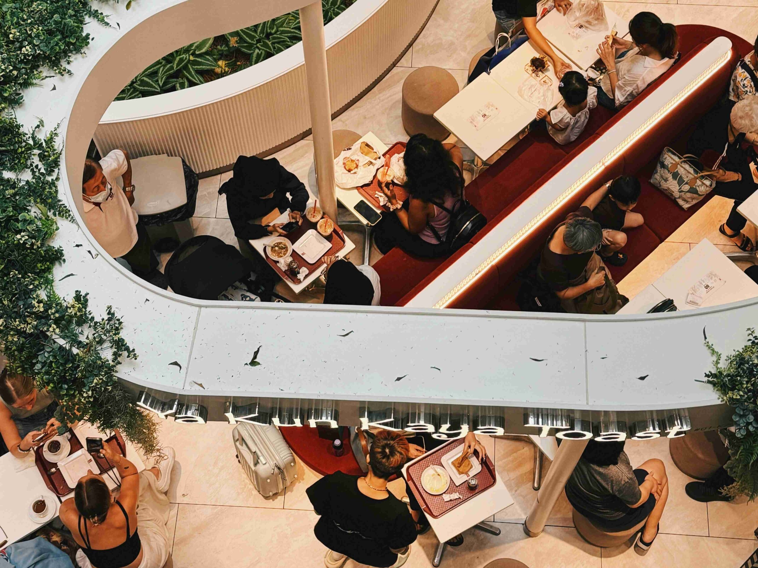 Diners enjoying meals at a stylish modern café in Singapore, symbolizing the mission to connect food lovers with exceptional dining experiences across the city.