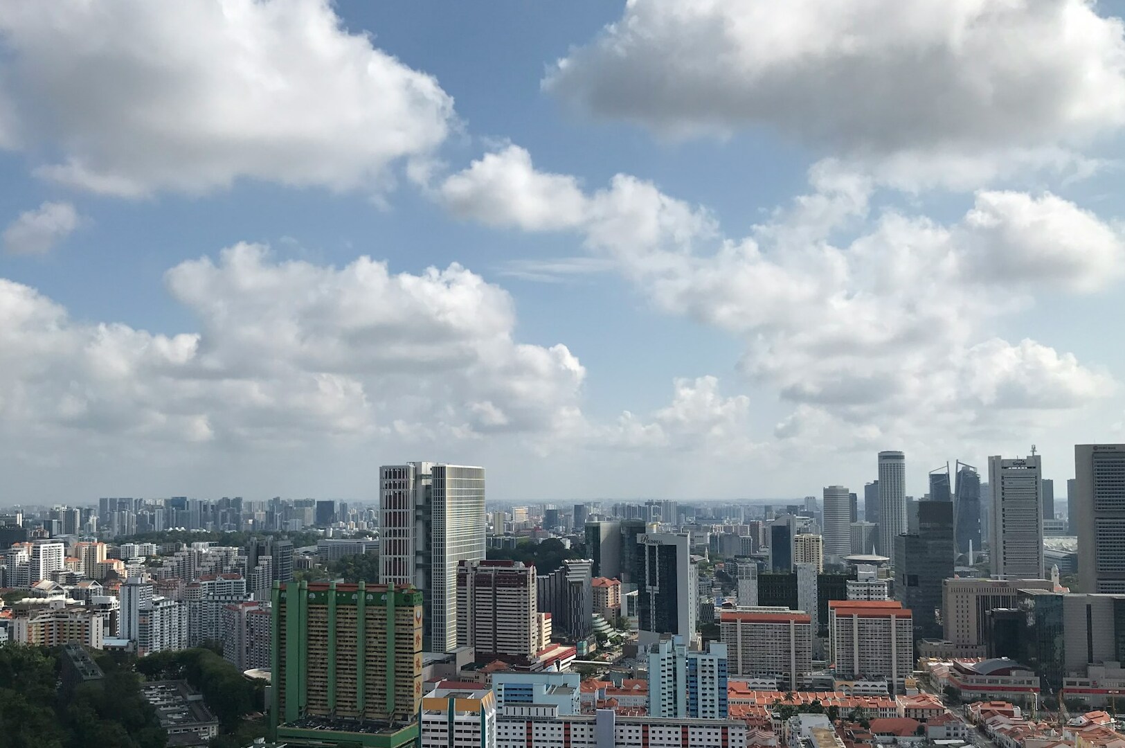 Singapore skyline featuring tall buildings under a cloudy sky, with a focus on Tanjong Pagar Food Centre's hours.