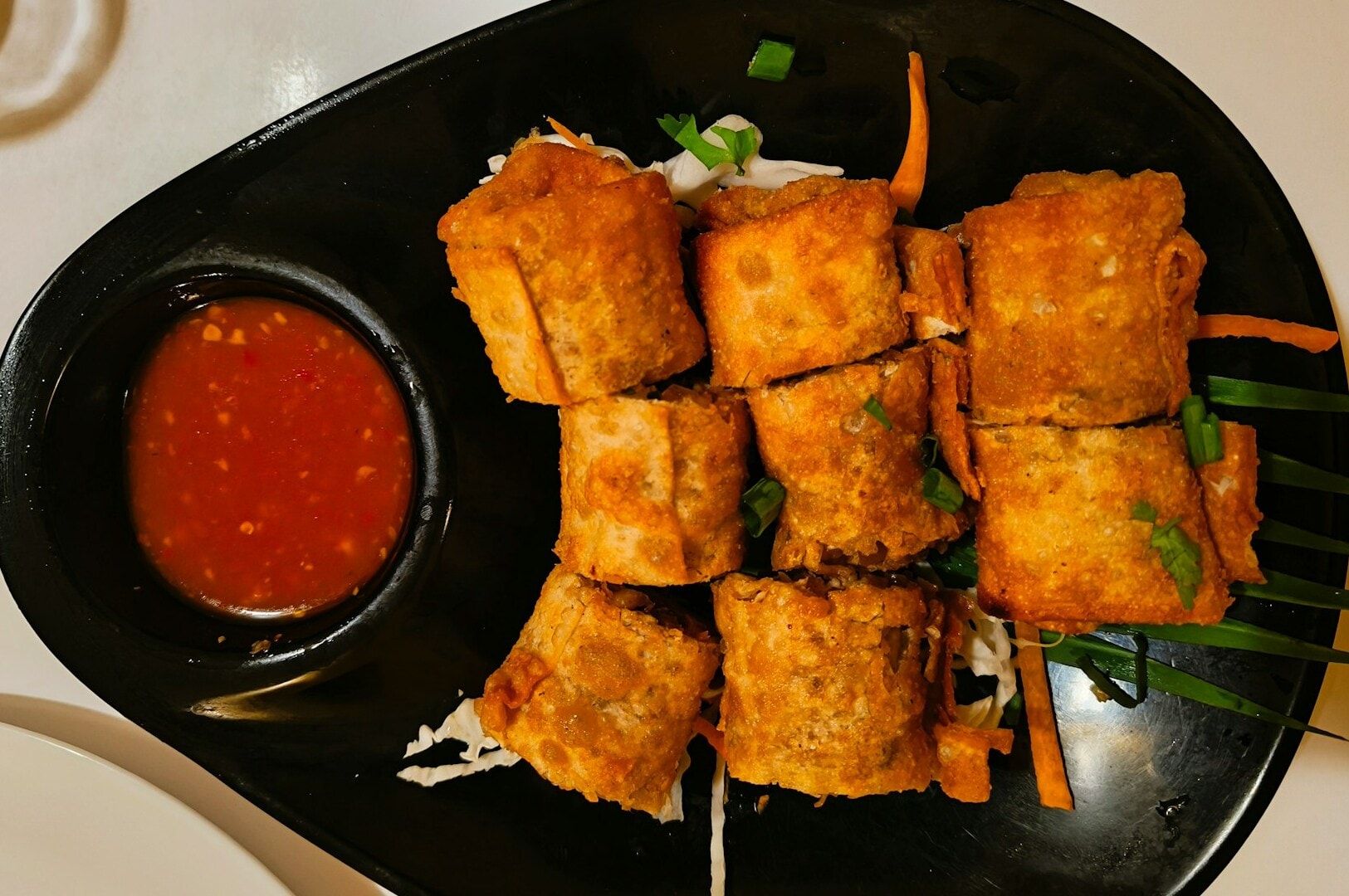 A beautifully arranged plate of modern Peranakan cuisine on a table, highlighting its rich flavors and presentation.