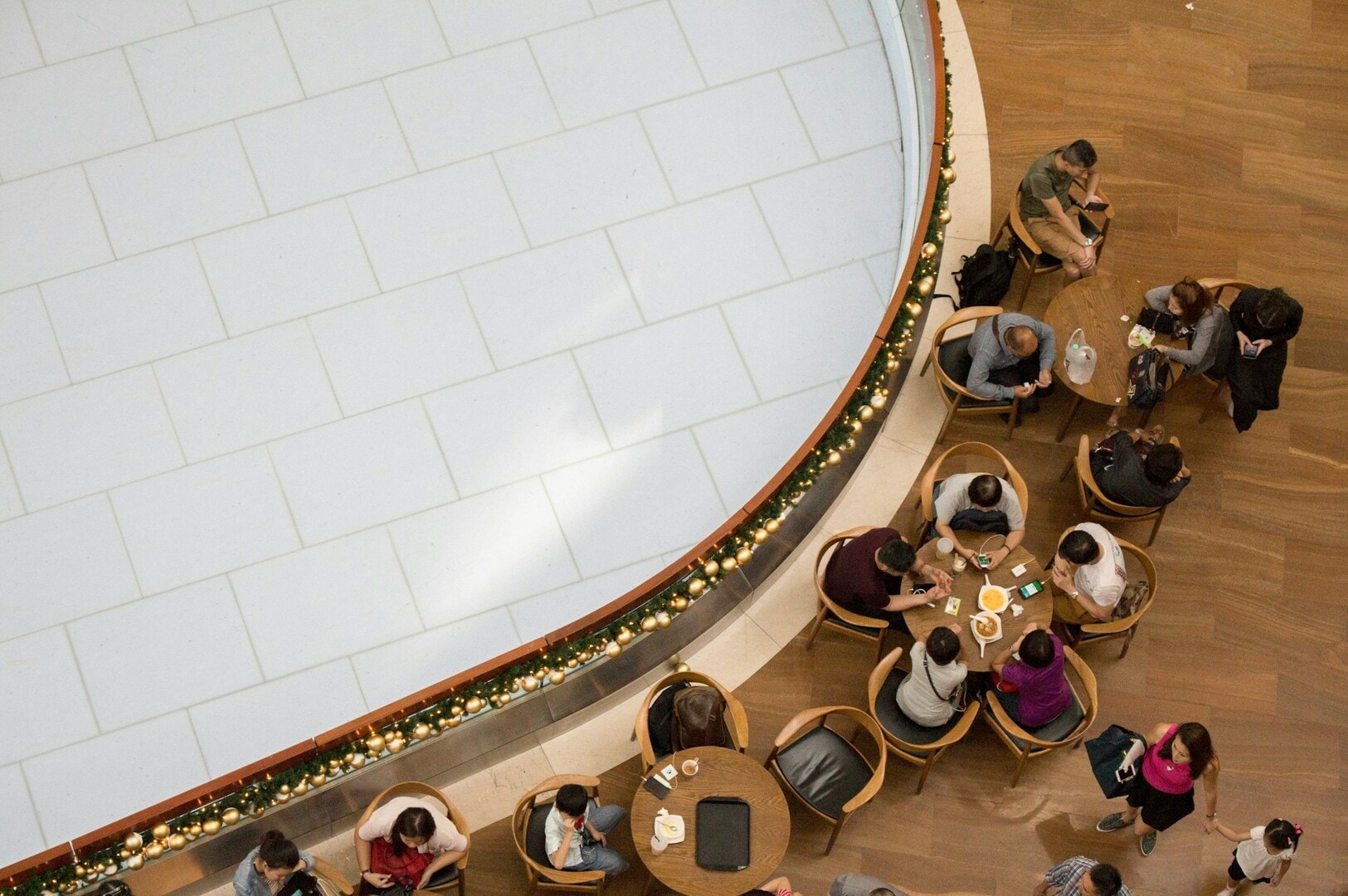 Patrons gathered around tables in a lively restaurant setting in Singapore, sharing food and conversation.