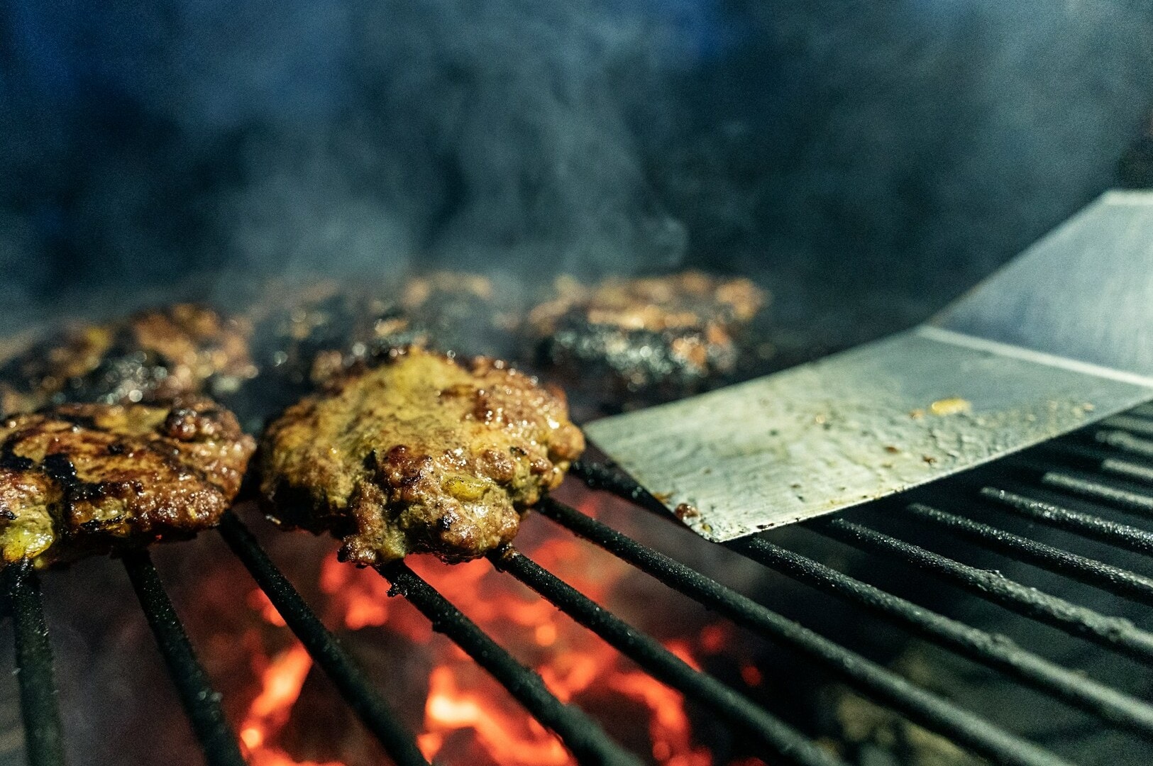 A close-up of meat grilling, highlighting the delicious offerings of Middle Eastern cuisine on Arab Street, Singapore.