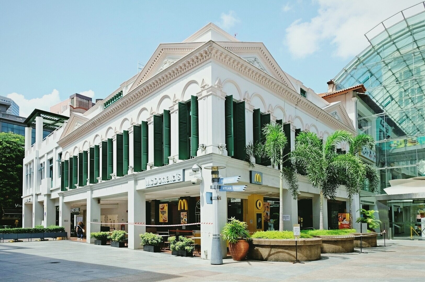A large white McDonald's restaurant in Singapore's East Coast, featuring green shutters on its windows.
