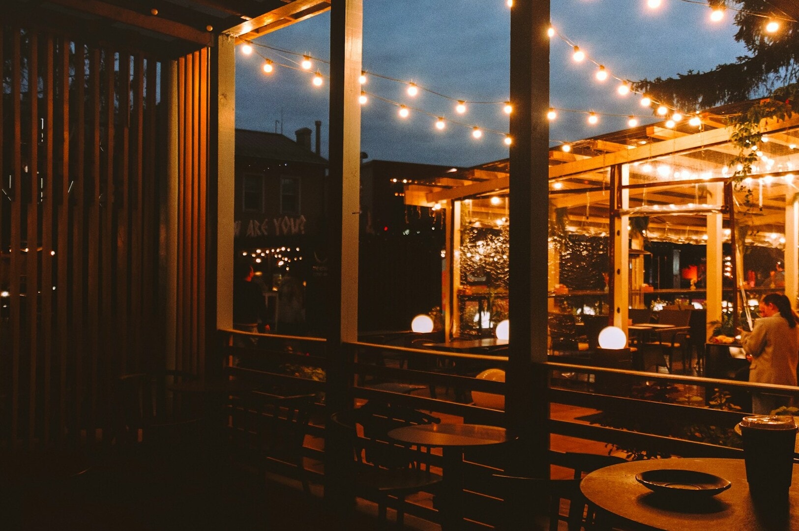 A cozy Singapore restaurant featuring string lights above, enhancing the ambiance for western dining experiences.