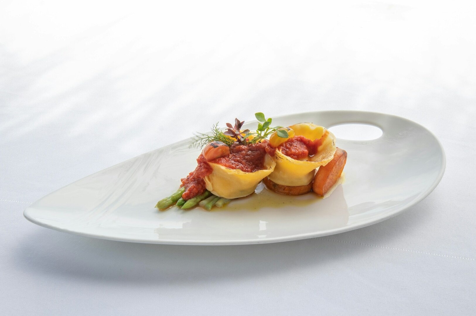 A white plate featuring an artistic dish, showcasing the elegance of Gastronomic Art.