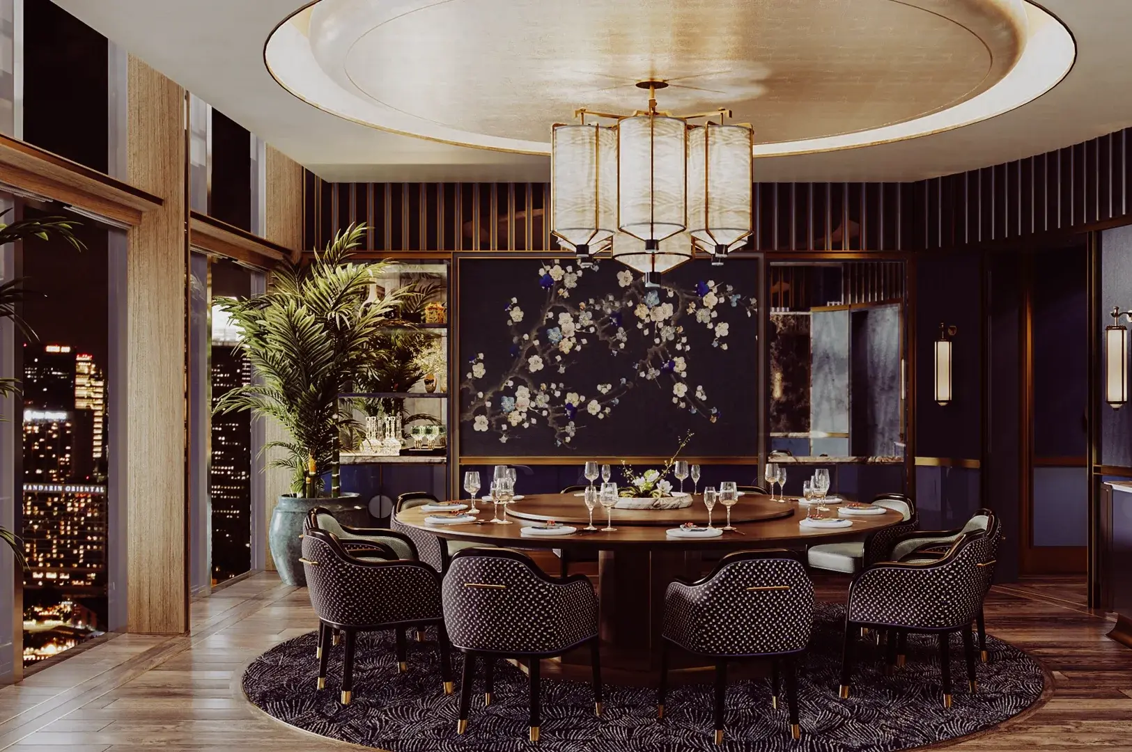 Elegant private dining room featuring a large round table, plush upholstered chairs, a statement chandelier, floor‑to‑ceiling windows with city views, and refined floral wall art.