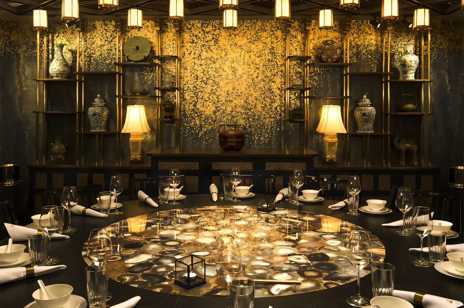 Luxurious private dining room in a fine Chinese restaurant featuring a round table with elegant place settings, illuminated hanging lanterns, and a golden decorative wall with ornate vases and artwork.
