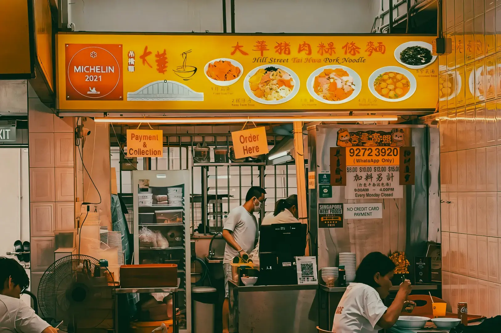Michelin-awarded Hill Street Tai Hwa Pork Noodle hawker stall in Singapore with kitchen and menu signage, highlighting iconic noodles and award-winning street food, frontal eye-level shot