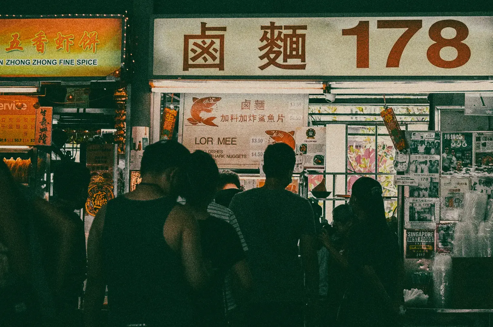 Crowded Singapore hawker stall selling Lor Mee noodles with waiting diners, illustrating authentic street food culture and local dining scene Singapore, rear eye-level candid shot