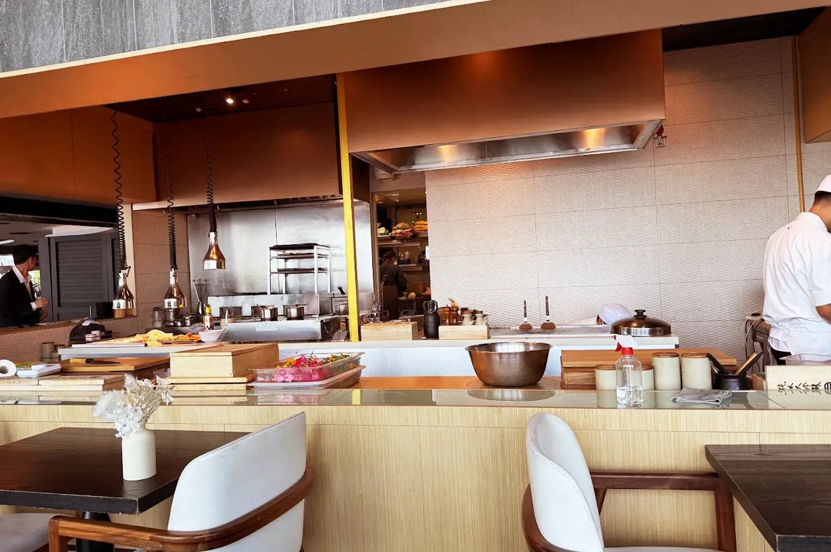 The open kitchen at OUMI, highlighting the meticulous preparation behind high-end Japanese dining.