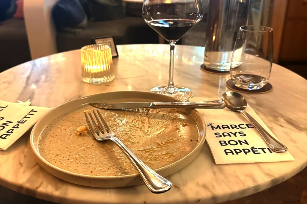 A candid scene of a single finished plate from Merci Marcel Orchard, a moment of enjoying food, company and memories when dining in Singapore.