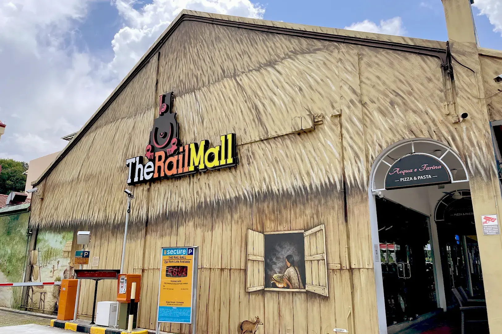 The exterior of The Rail Mall location of Acqua e Farina's original outlet, featuring unique wall murals and the restaurant's distinct branding.