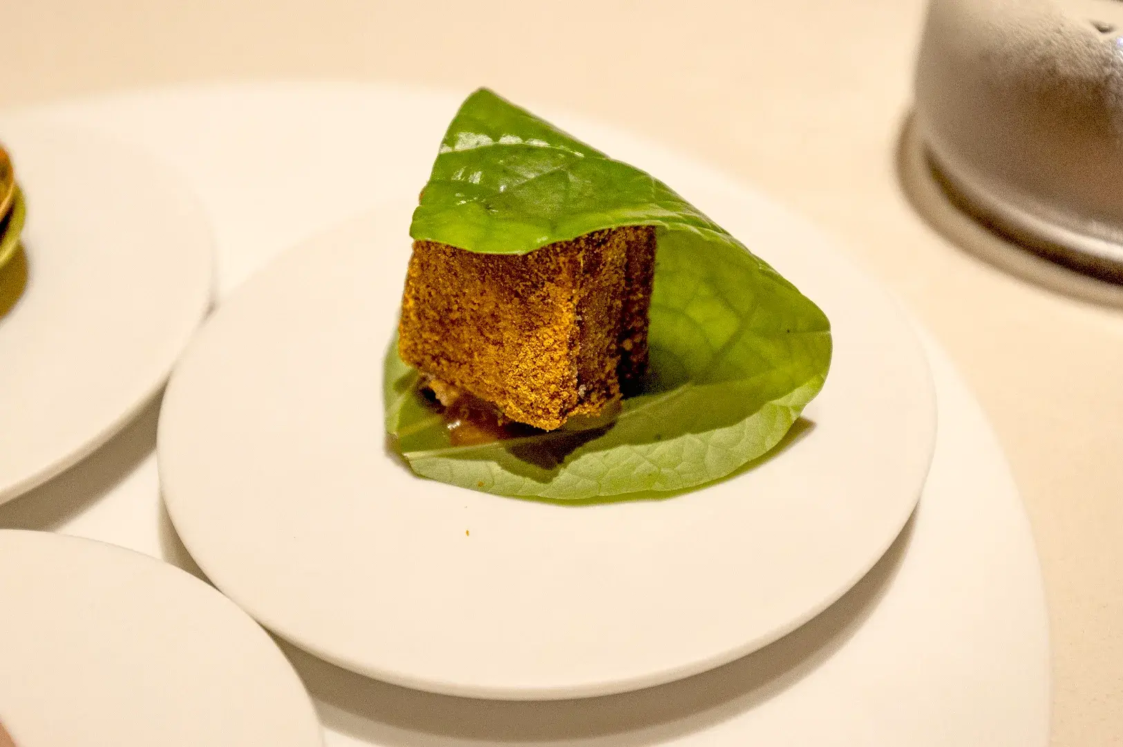 An elegant, bite-sized appetizer served at Thevar Singapore, the crispy pork sambal aioli, highlighting Chef Mano Thevar’s artful presentation and fusion of traditional spices with modern techniques.