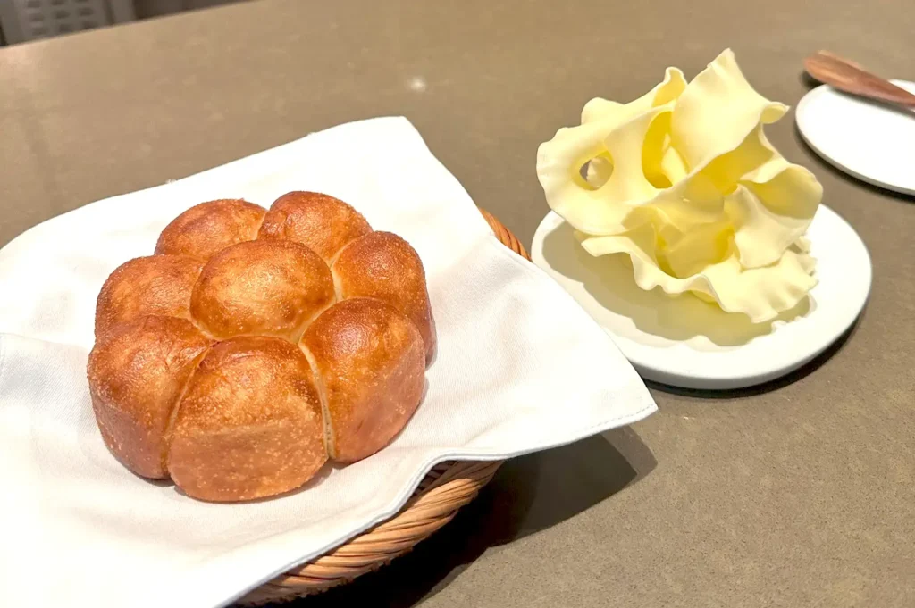 Roti Paung served with Johorean milk butter sculptures at Seroja, highlighting fine dining inspired by the Malay Archipelago.