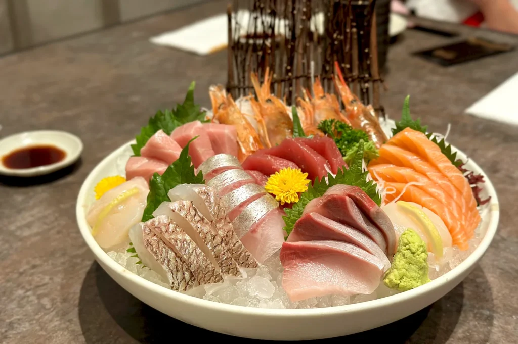A generous sashimi moriawase platter with tuna, salmon, yellowtail, and shrimp on crushed ice at Sen-ryo, ION Orchard, Singapore.
