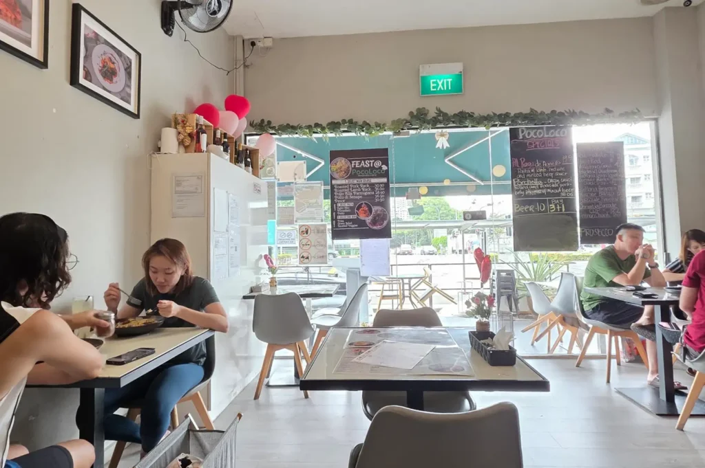 Interior view of a casual, cozy restaurant with regular patrons dining at tables, illustrating how faithful locals understand a eatery's true character beyond online reviews.