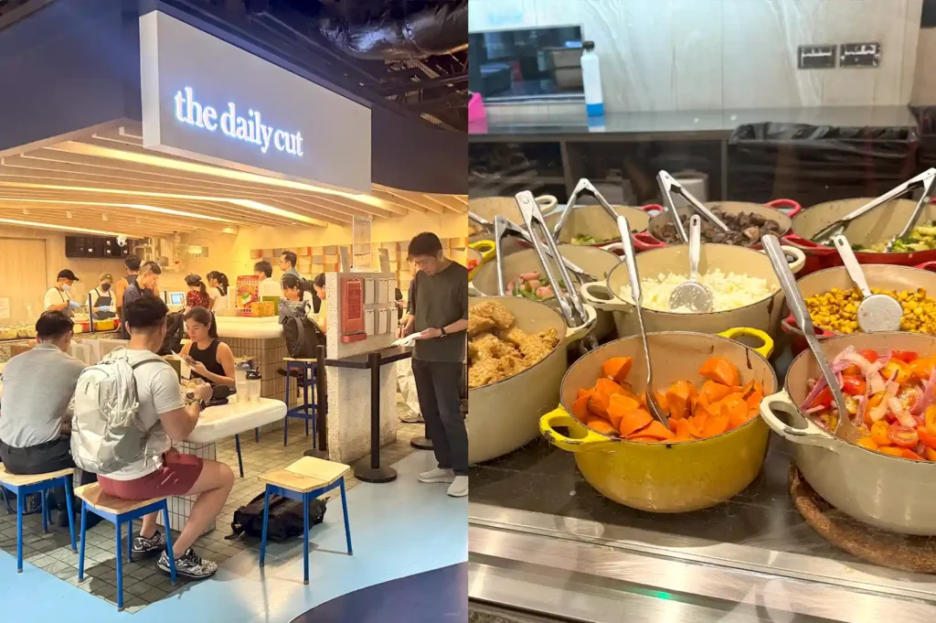The Daily Cut counter area featuring patrons dining inside, alongside a display of fresh, colorful ingredients in warm cast-iron pots for customizable food bowls.