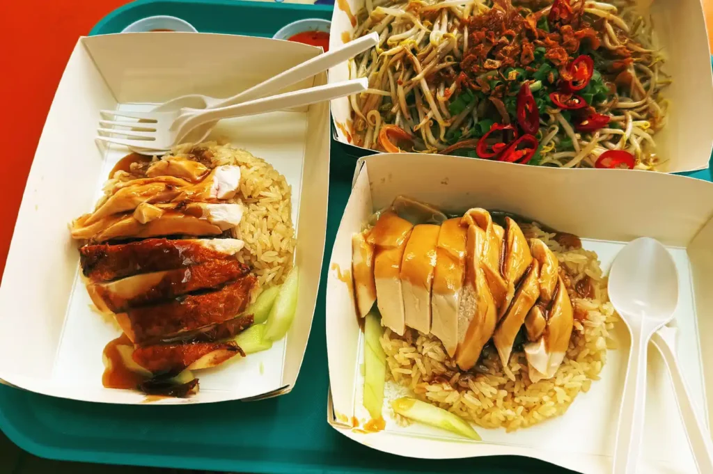 A spread of local Singaporean comfort favorites including roasted and white chicken rice, reflecting how deeply rooted culinary preferences spark debates on favorite foods