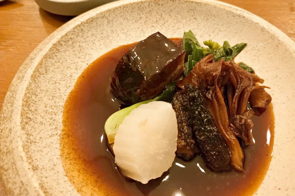 Tau Yu Bak, a savory braised pork and mushroom dish cooked to tender perfection with rich spices and herbs.